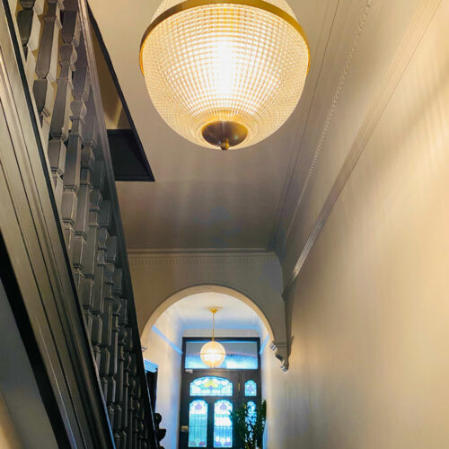 small Holophane style pendant in hallway