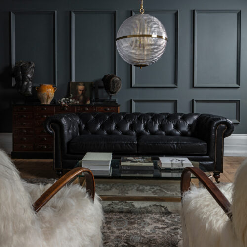 vintage Halabala armchairs, black leather Chesterfield sofa, vintage Holophane inspired lighting