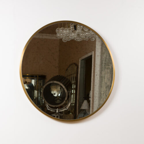 round brass mirror with aged glass