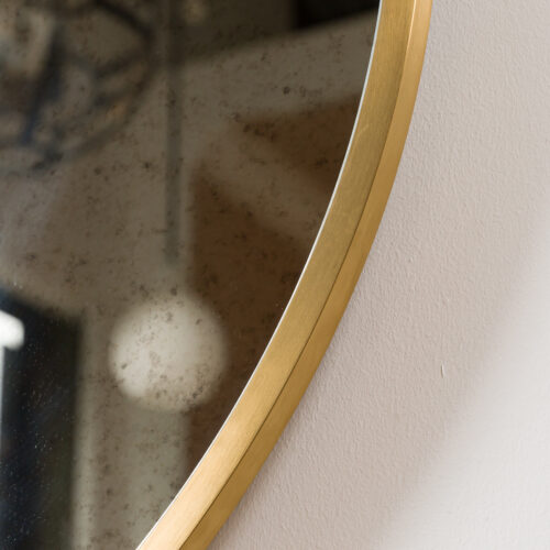 round brass mirror with aged glass