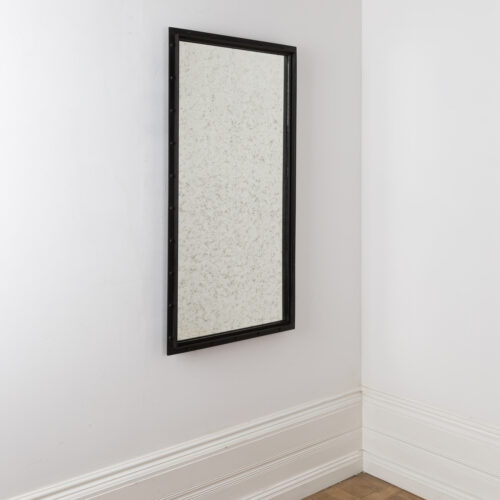 aged glass rectangular mirror with a black industrial frame ideal for hallways or living rooms