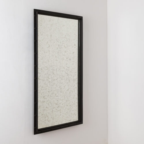 aged glass rectangular mirror with a black industrial frame ideal for hallways or living rooms