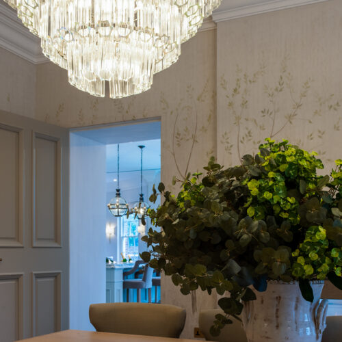 large clear glass chandelier in a tiered formation in a project by Tile House Studio interior designers