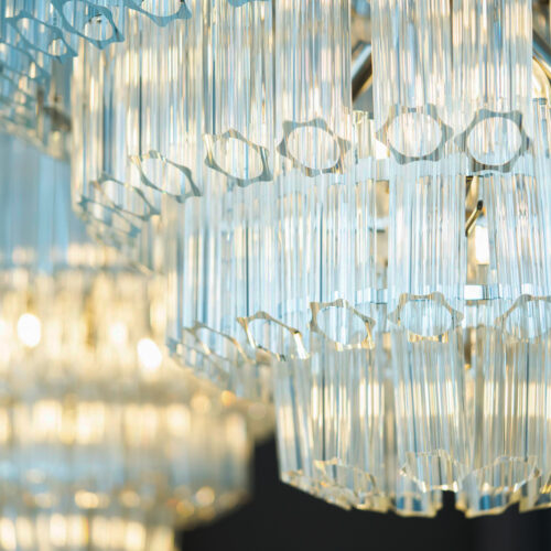 large clear glass chandelier in a tiered formation in a project by Tile House Studio interior designers
