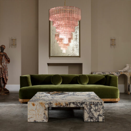 smoked pink or clear glass tiered chandelier in mid-century style with a large square Viola marble coffee table and green velvet sofa