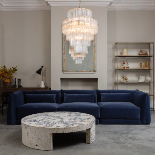 Milano cornflower blue sectional sofa with mid-century inspired clear glass chandelier