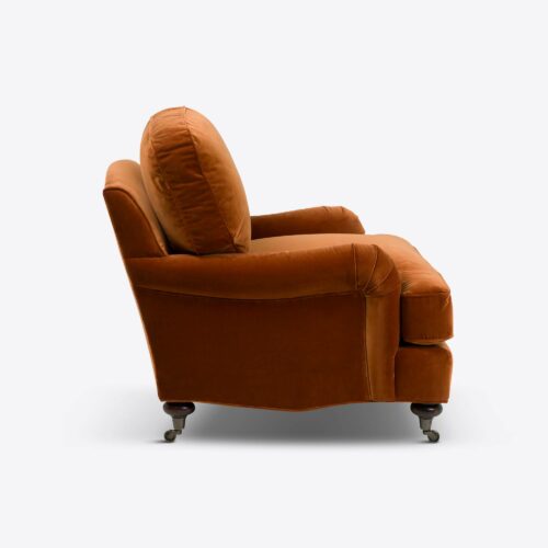 Rust velvet traditional armchair on castors