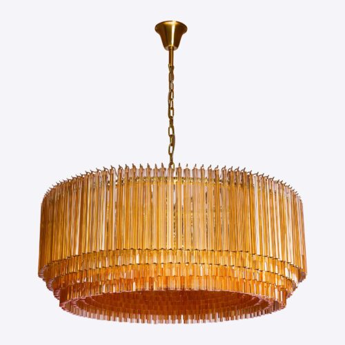 Grande Amber Amaro - large amber drum triedri chandelier in mid-century Murano glass style hanging over a red square marble coffee table