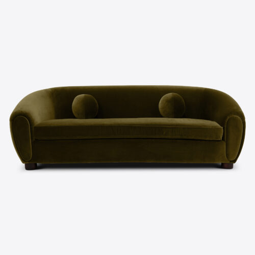 mid-century inspired curved sofa in green velvet